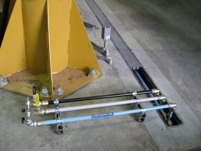 blue white and gray piping come out of the floor